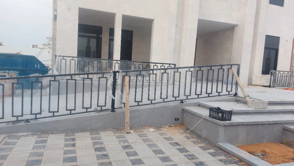 Metal railing around a raised terrace