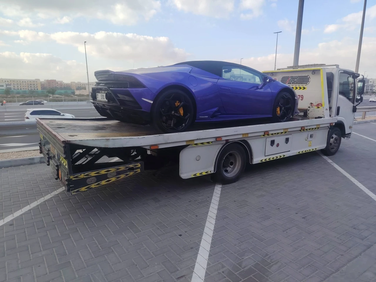 Blue sports car on a flatbed