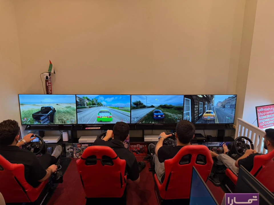 Players using adjacent racing simulators at PS Game Drive